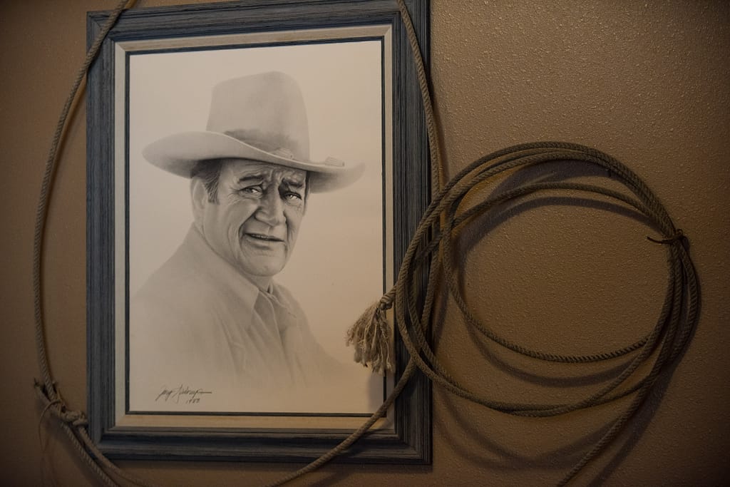 Photo of drawing of The Duke John Wayne with rope around the frame