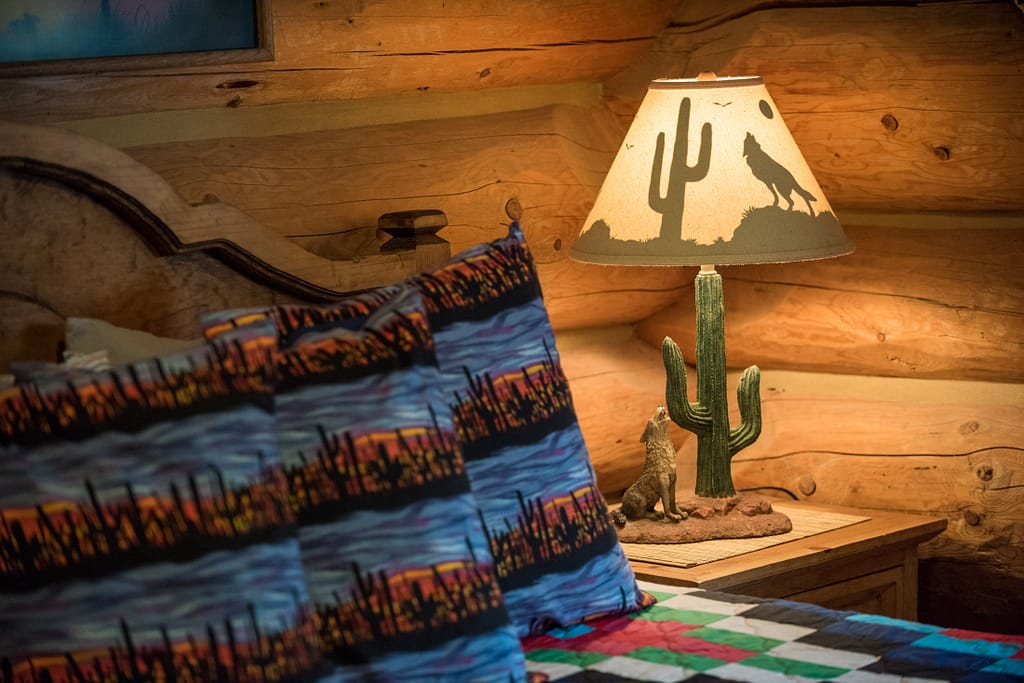 Western Pleasure Guest Ranch Siesta Room bed with pillows and cactus lamp